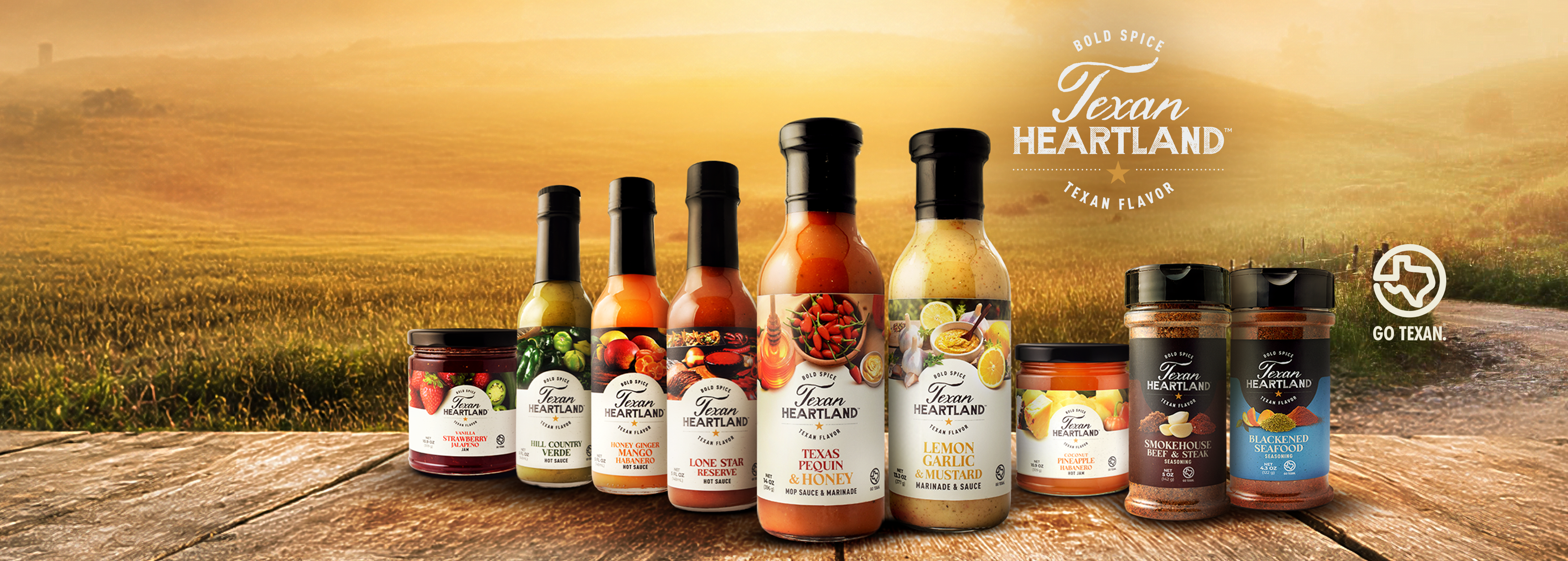Texan Heartland hot sauces, cooking sauces, seasonings and gourmet jams displayed on a Texas porch at dusk.